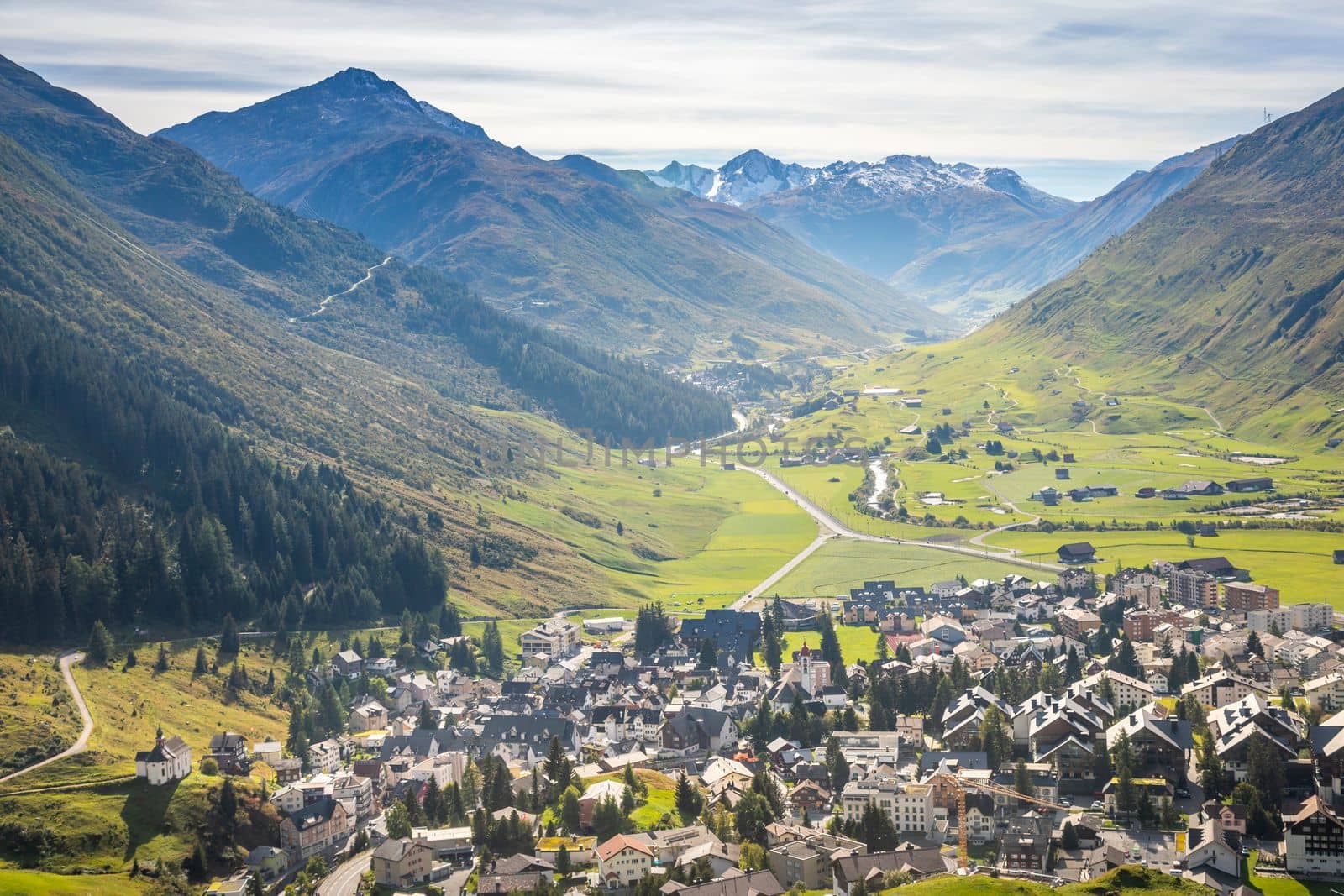 Idyllic landscape of Andermatt village in Urseren valley at sunny springtime, Swiss Alps, Switzerland