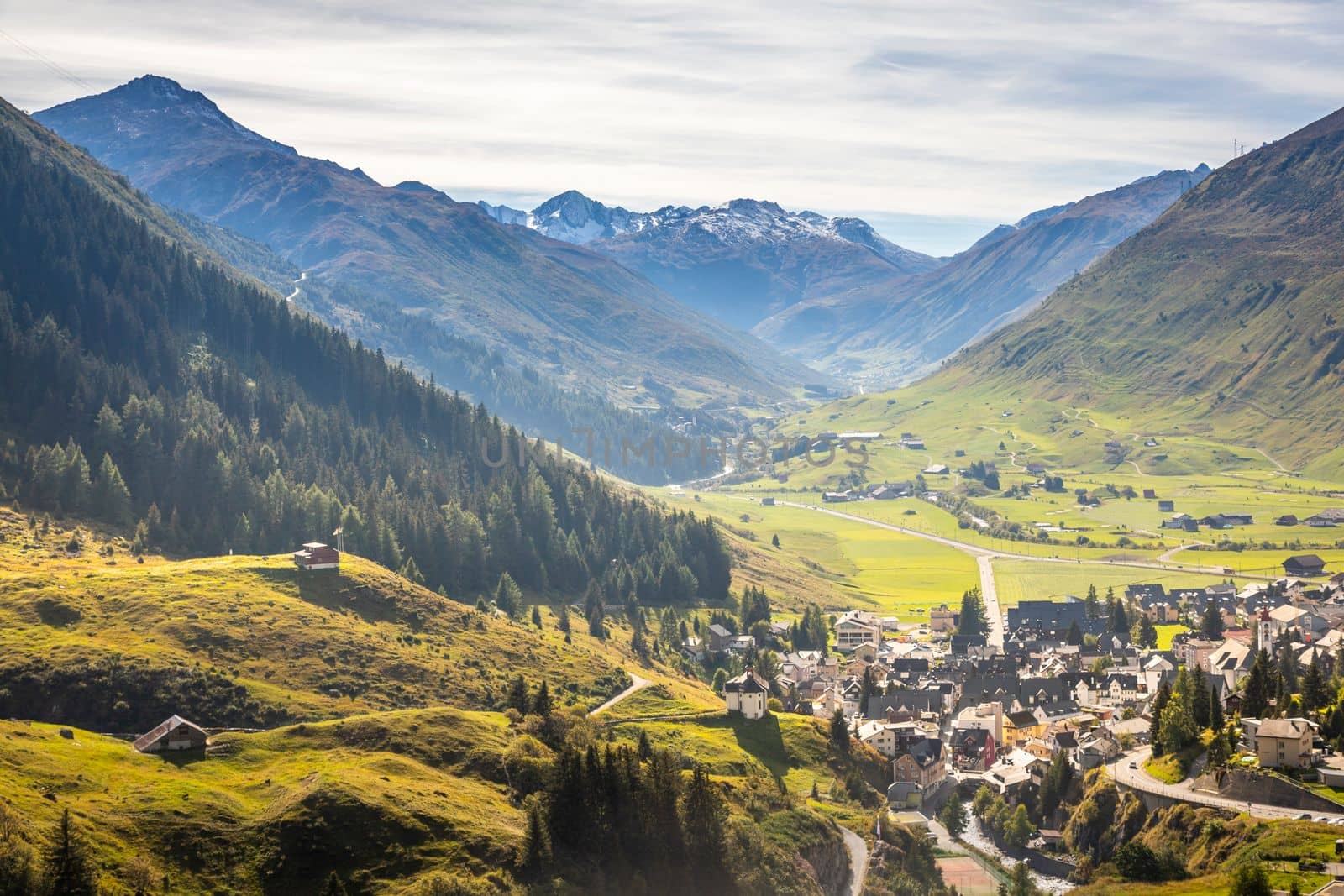 Idyllic landscape of Andermatt village in Urseren valley at sunny springtime, Swiss Alps, Switzerland
