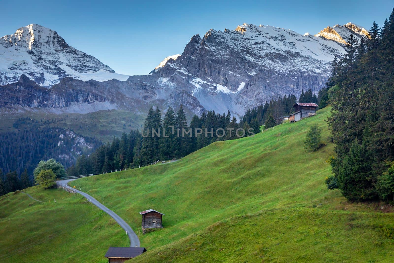 Top of the Schilthorn and view of Snowcapped Bernese Swiss alps and alpine farms, Switzerland