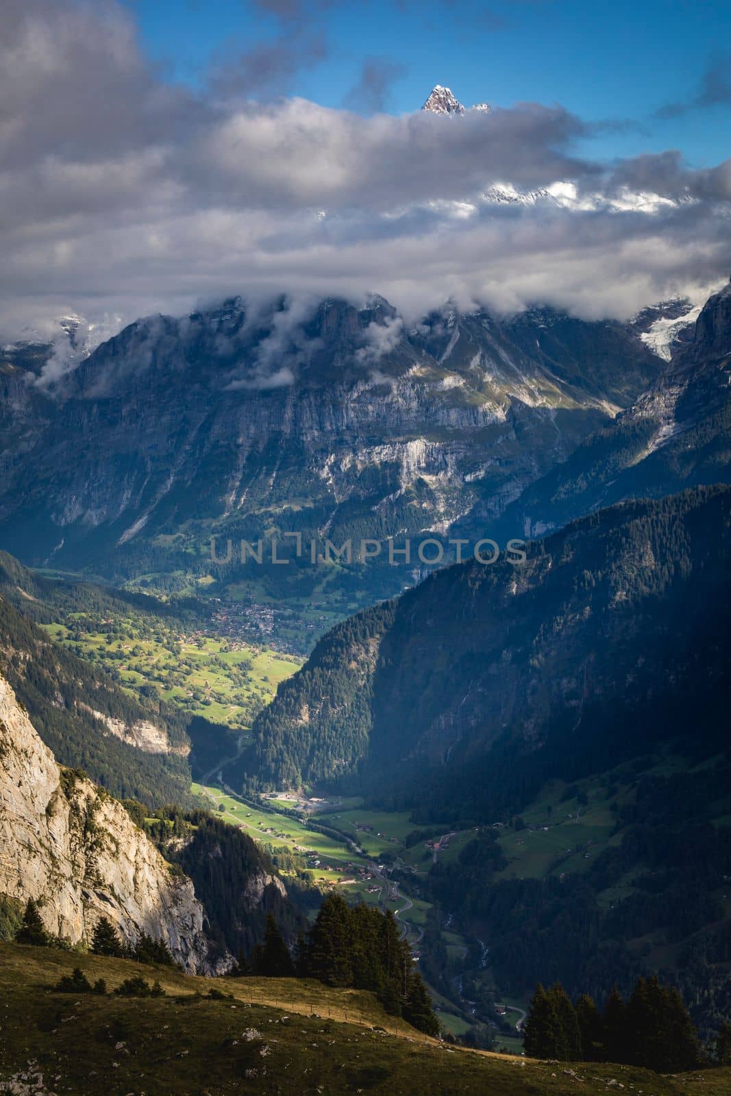 Misty Mountain above Grindelwald valley, Snowcapped Bernese Swiss alps at sunset, Switzerland