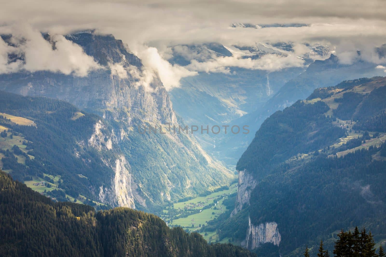 Misty Jungfrau range above Lauterbrunnen valley, Snowcapped Bernese Swiss alps, Switzerland