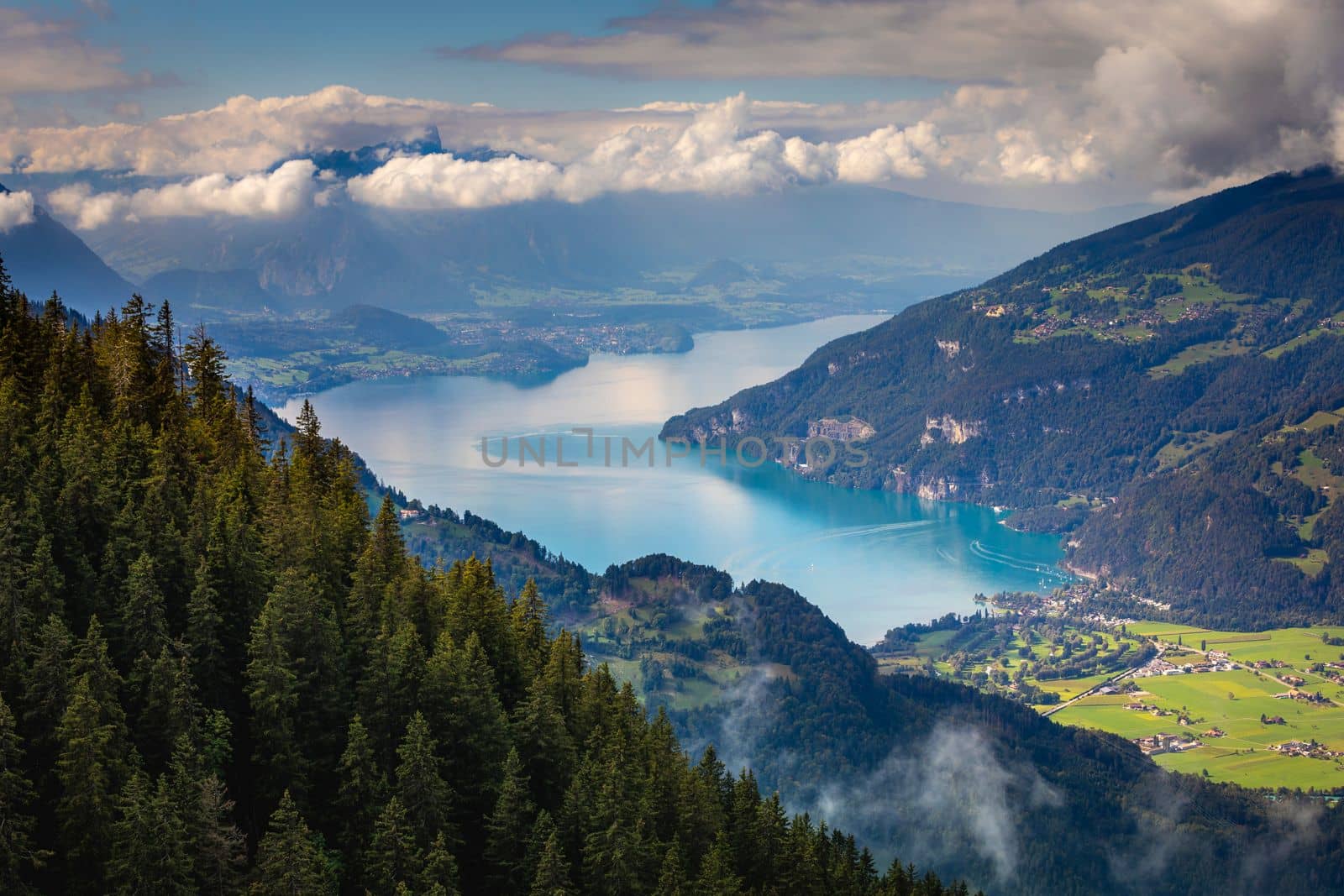 Aerial view of Swiss Alps and Lake Thun at dramatic sunset, Interlaken, Switzerland