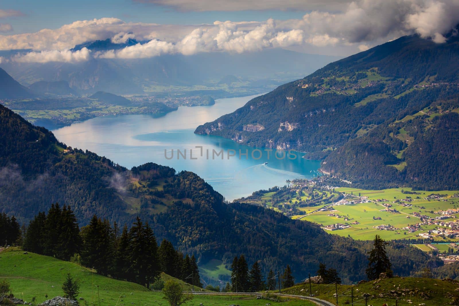 Aerial view of Swiss Alps and Lake Thun at dramatic sunset, Interlaken, Switzerland