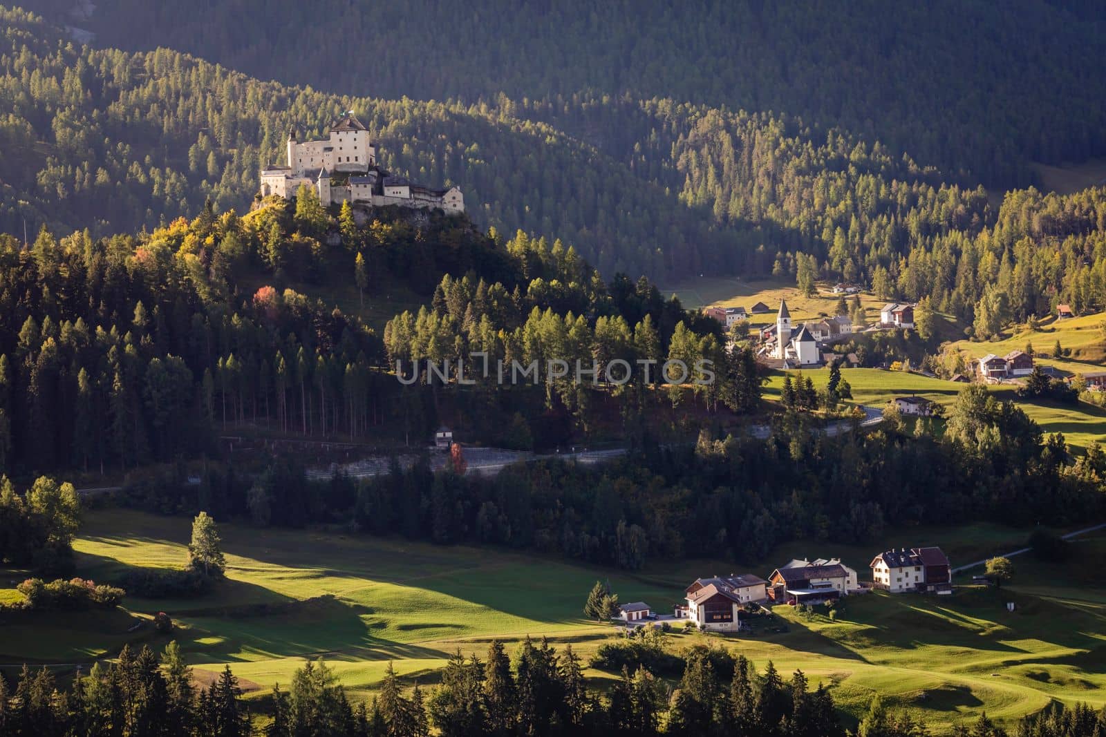 Above Idyllic landscape of Scuol Tarasp village at sunrise, Engadine, Swiss Alps, Switzerland