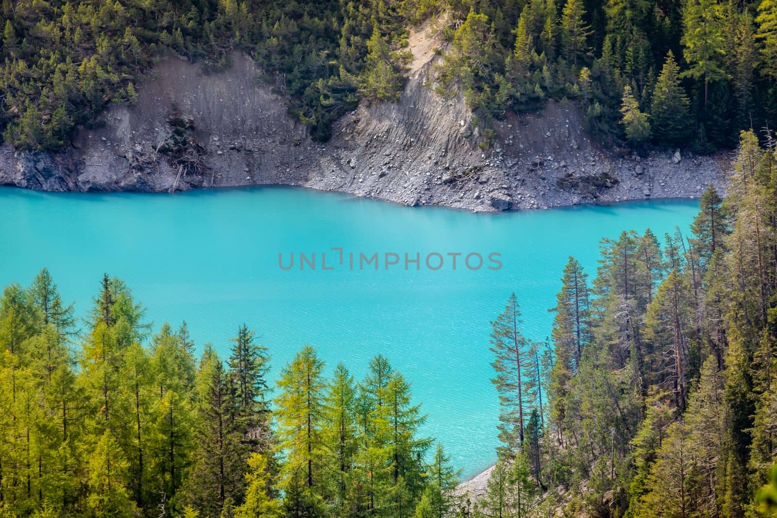 Turquoise alpine lake in Swiss national park at sunny day, Switzerland