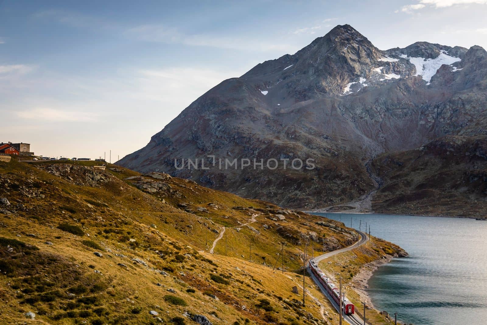 Swiss train in the alps and lake around Bernina pass, Engadine valley, Switzerland