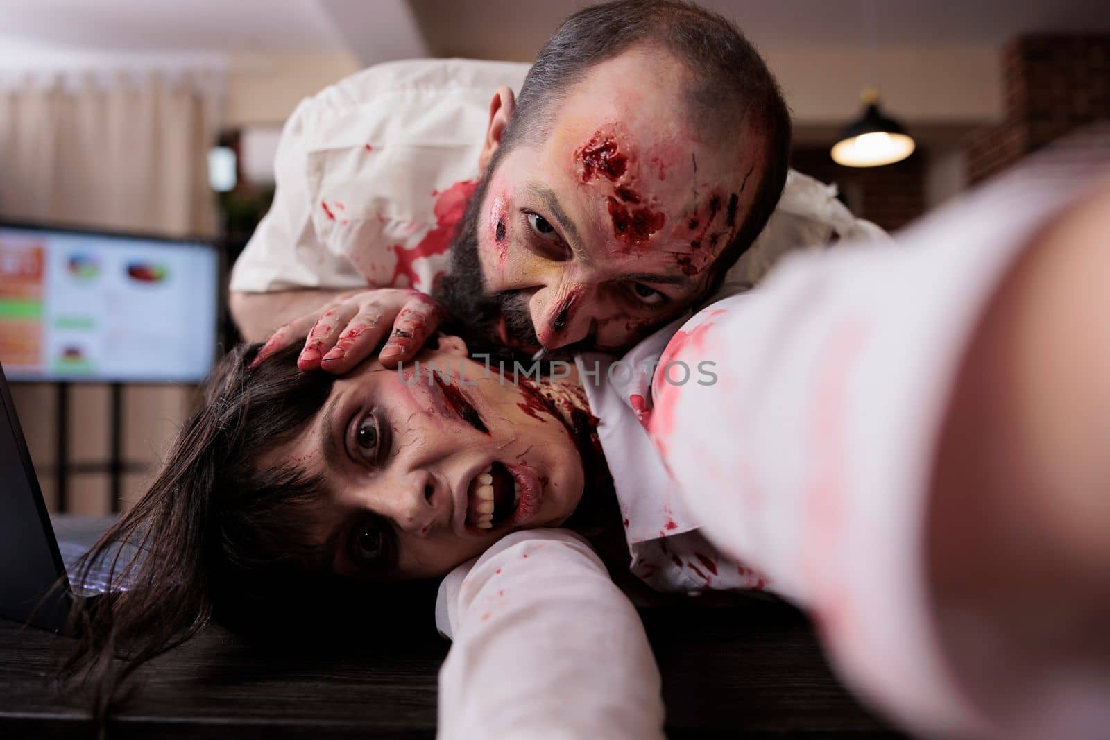 Scary horror zombies biting wounds in office by DCStudio