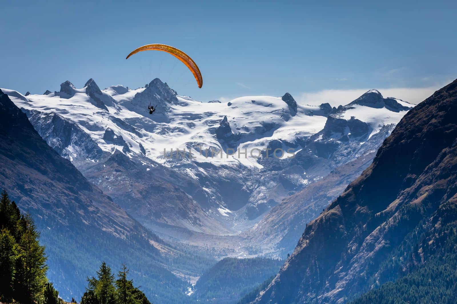 Paragliding above Bernina and Palu mountain range with glaciers in the Swiss Alps, Engadine, Switzerland