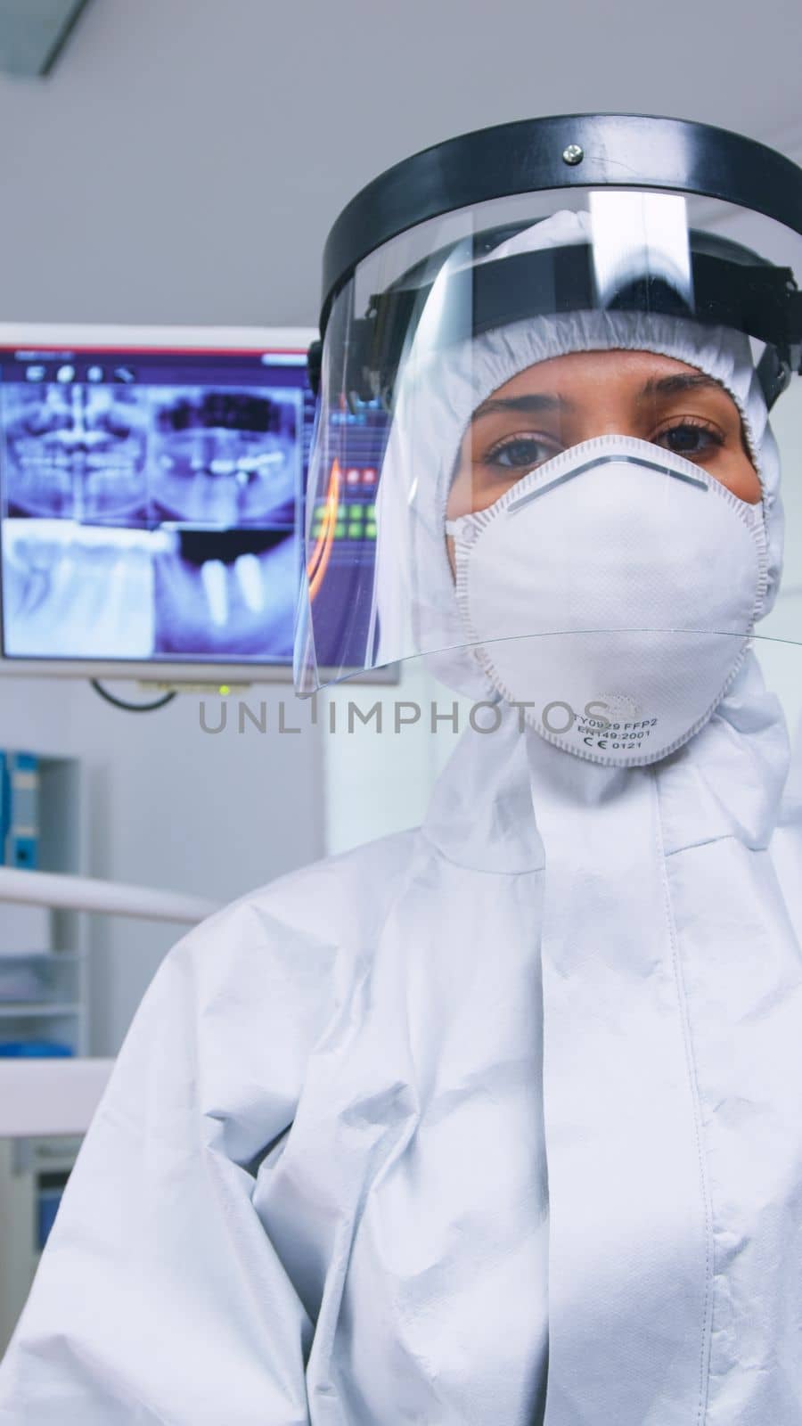 Patient pov while dentist in protective suit against covid exami by DCStudio