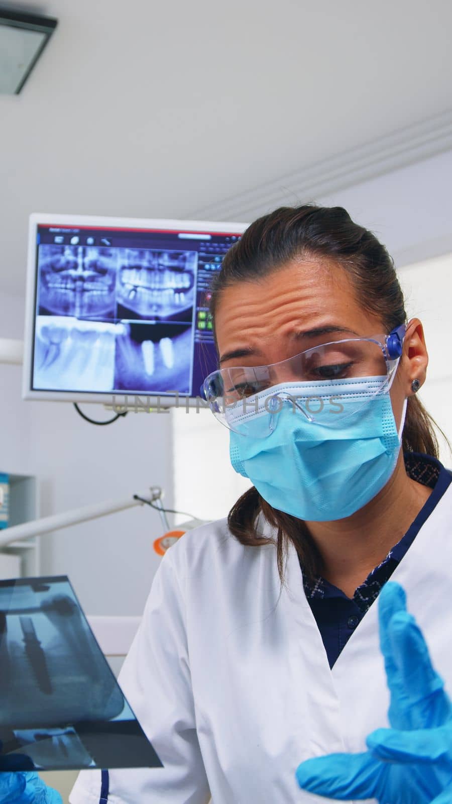 Patient pov in dental office explaining treatment of teeth cavit by DCStudio