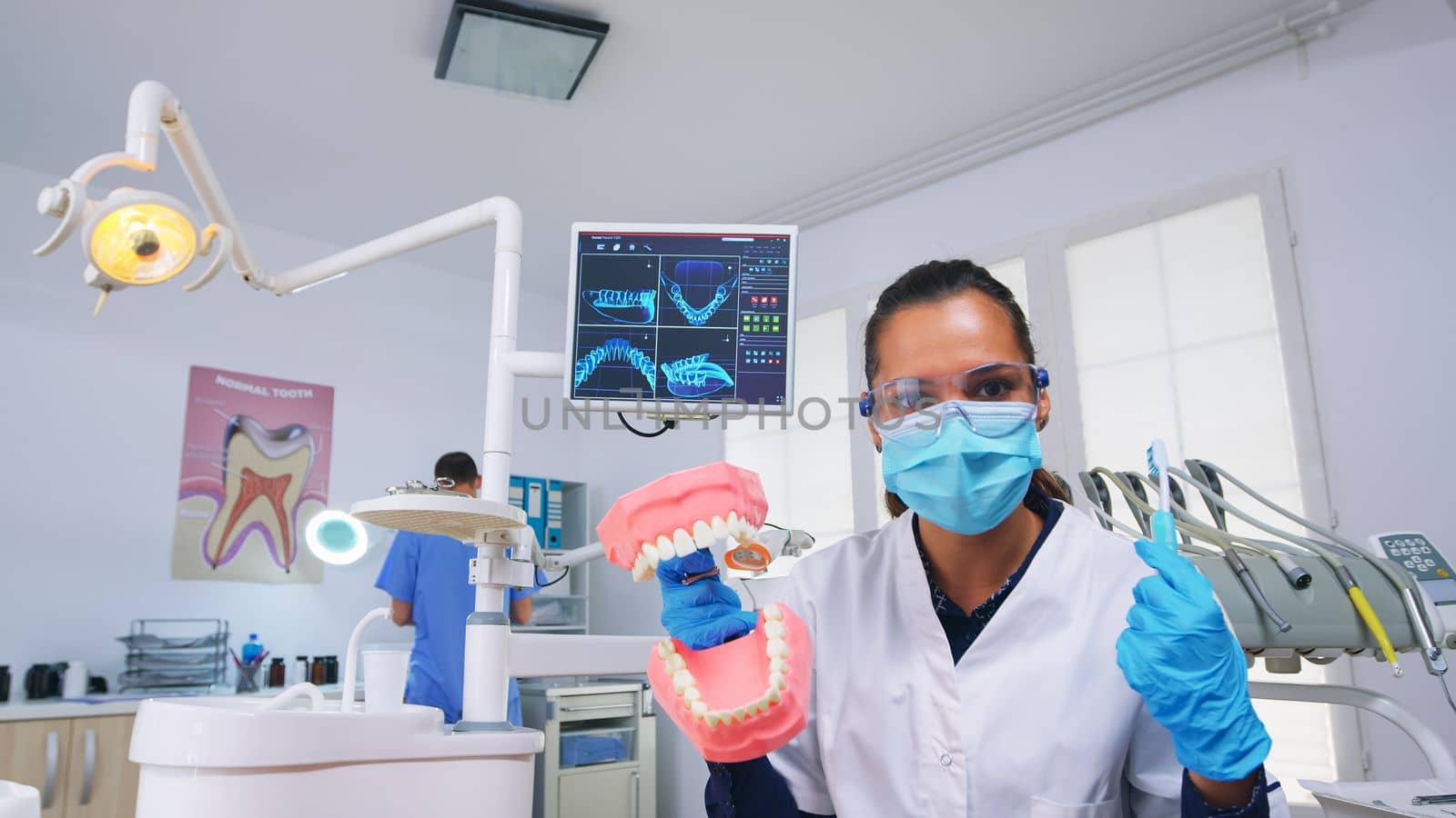 Patient pov of dentist teaching correct cleaning of teeth by DCStudio