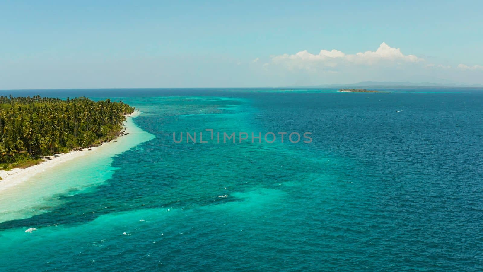 Sandy beach and tropical island by atoll with coral reef, top view. Patongong Island with sandy beach. Summer and travel vacation concept.