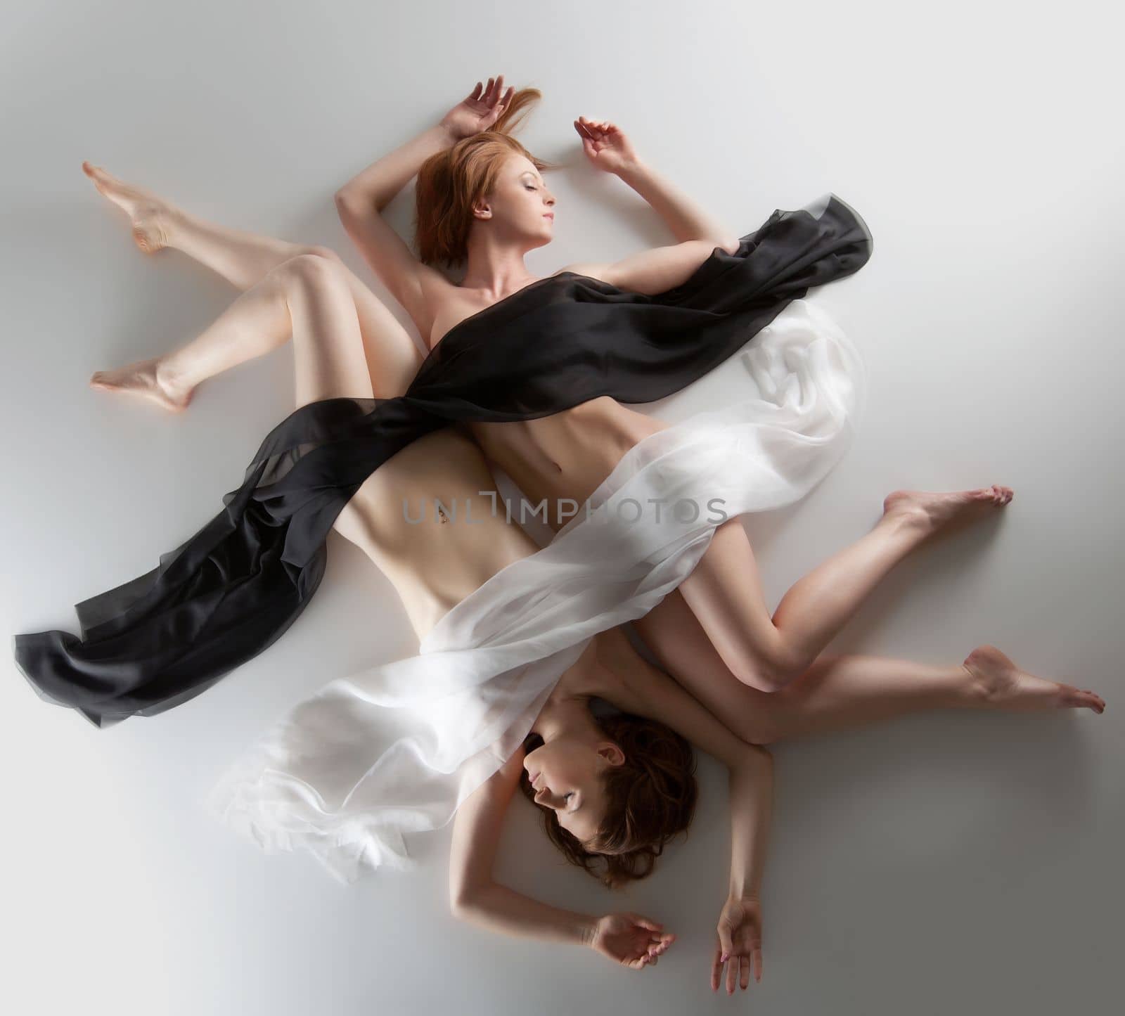 Beauty naked woman yin yang position lay under veil