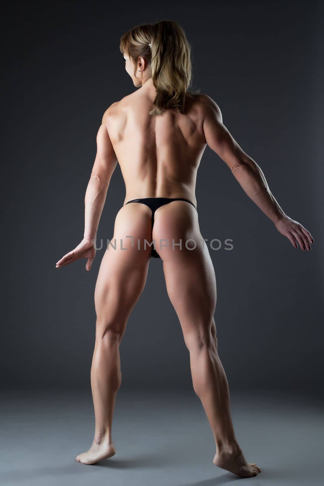 Heavy body builder woman posing naked in studio