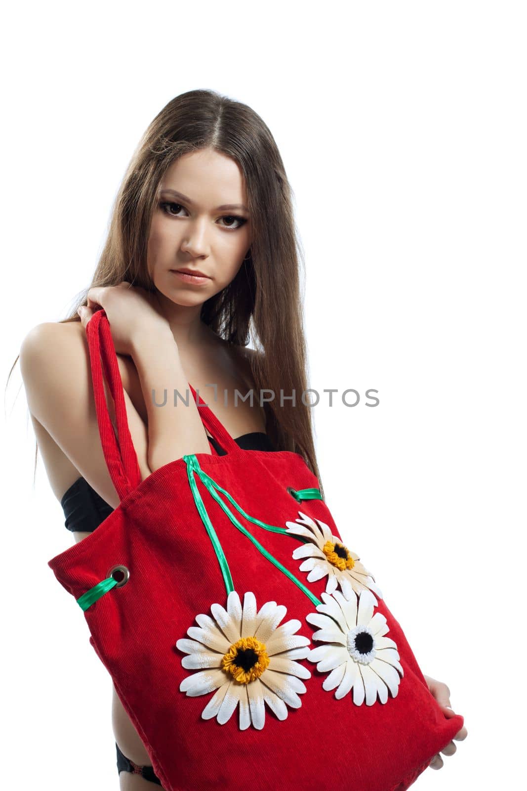Yong woman portrait with red beach bag with flowers isolated