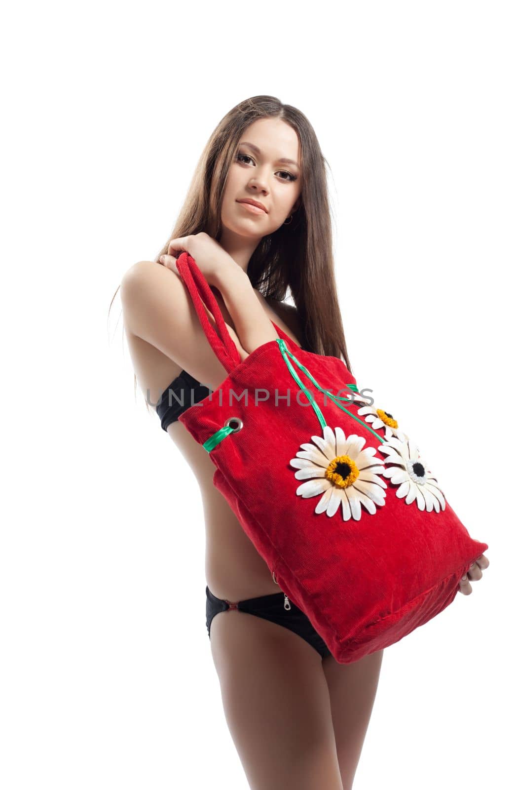 Yong woman show her red beach bag isolated in black bikini