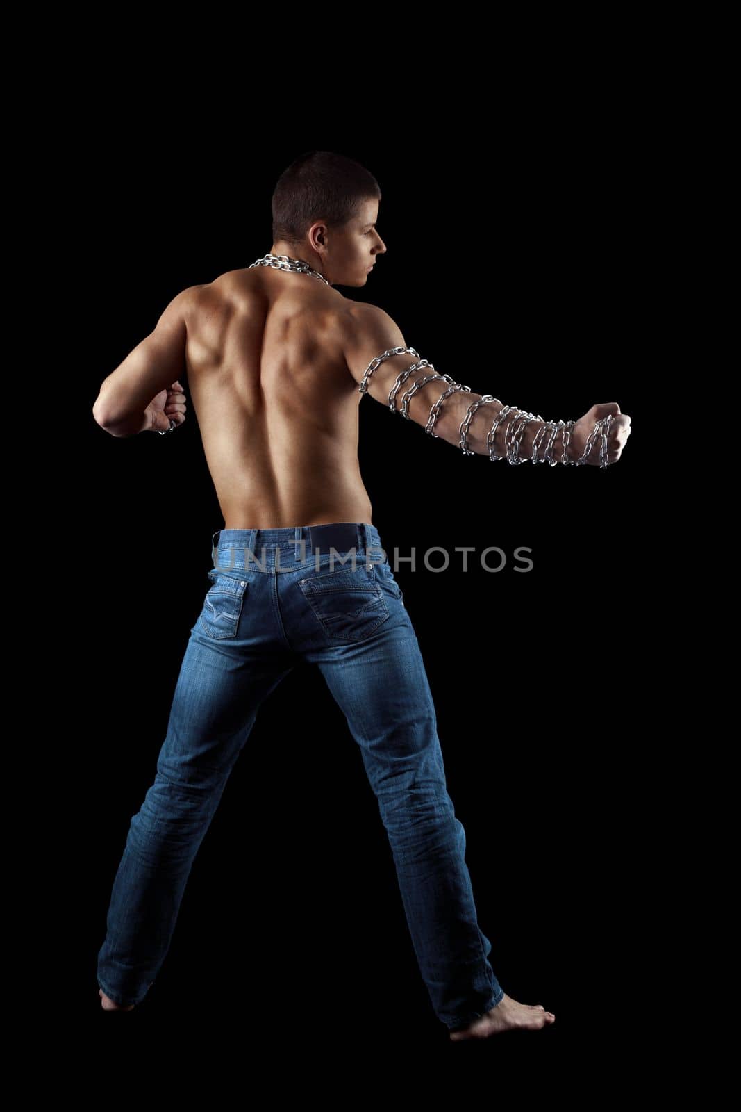yong athletic naked man posing with chain on hands