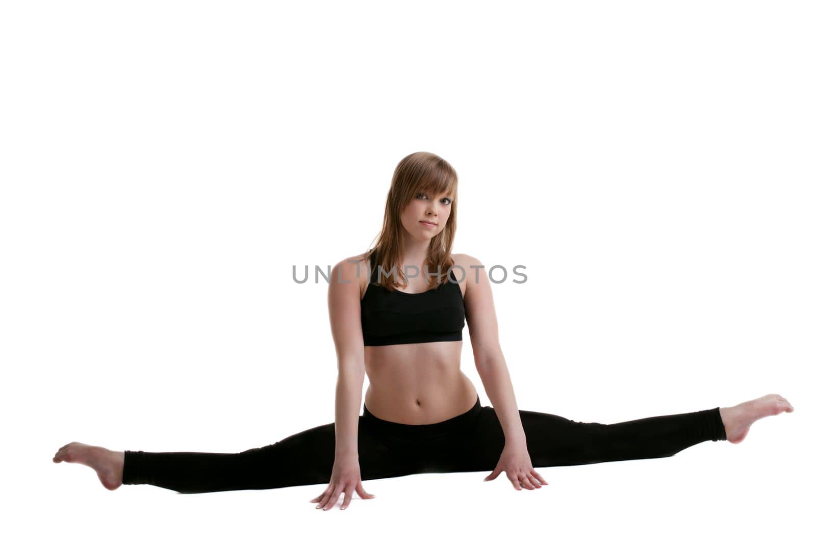 young gymnast in black show split isolated