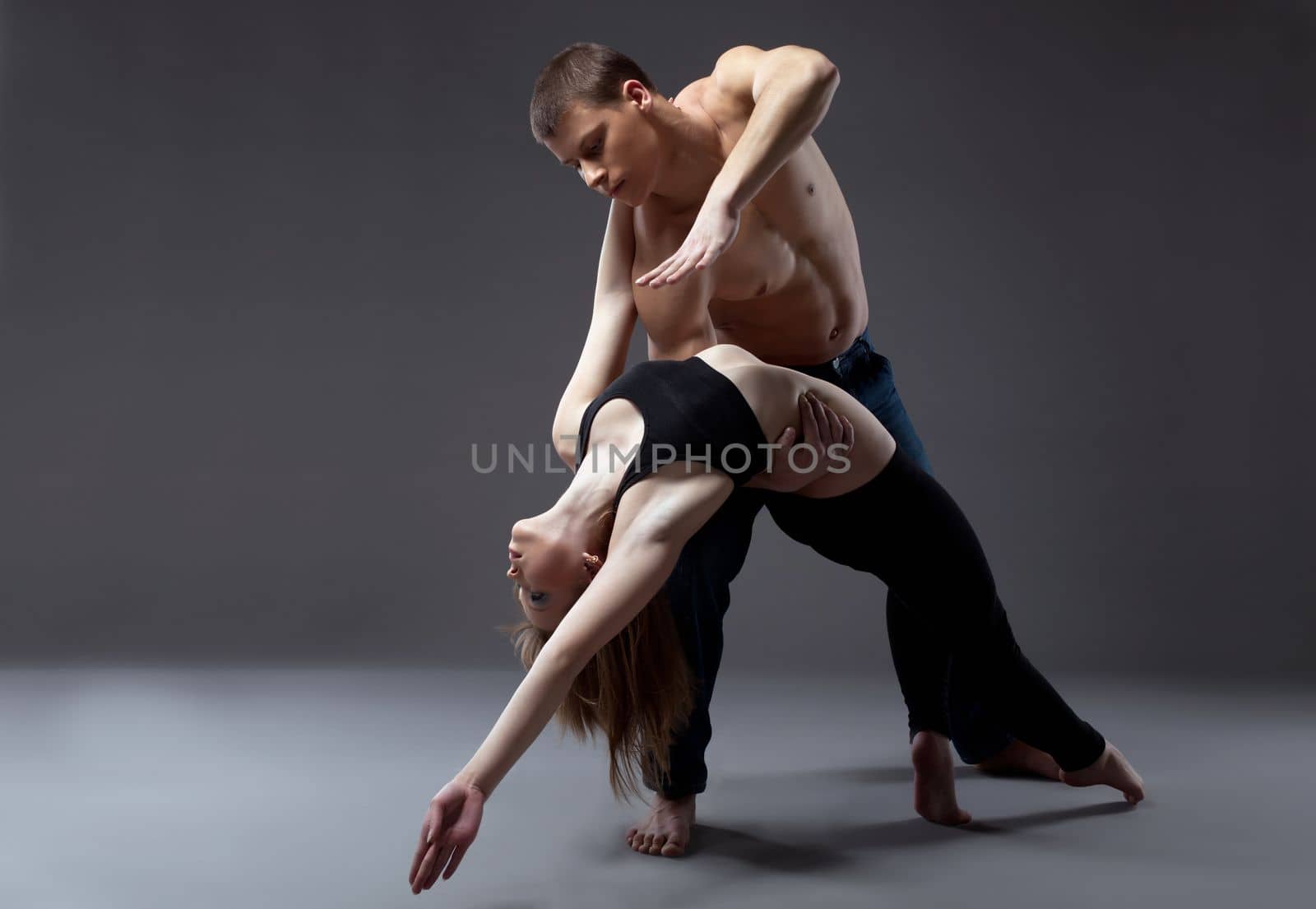 Couple of young gymnast posing in dance performance isolated