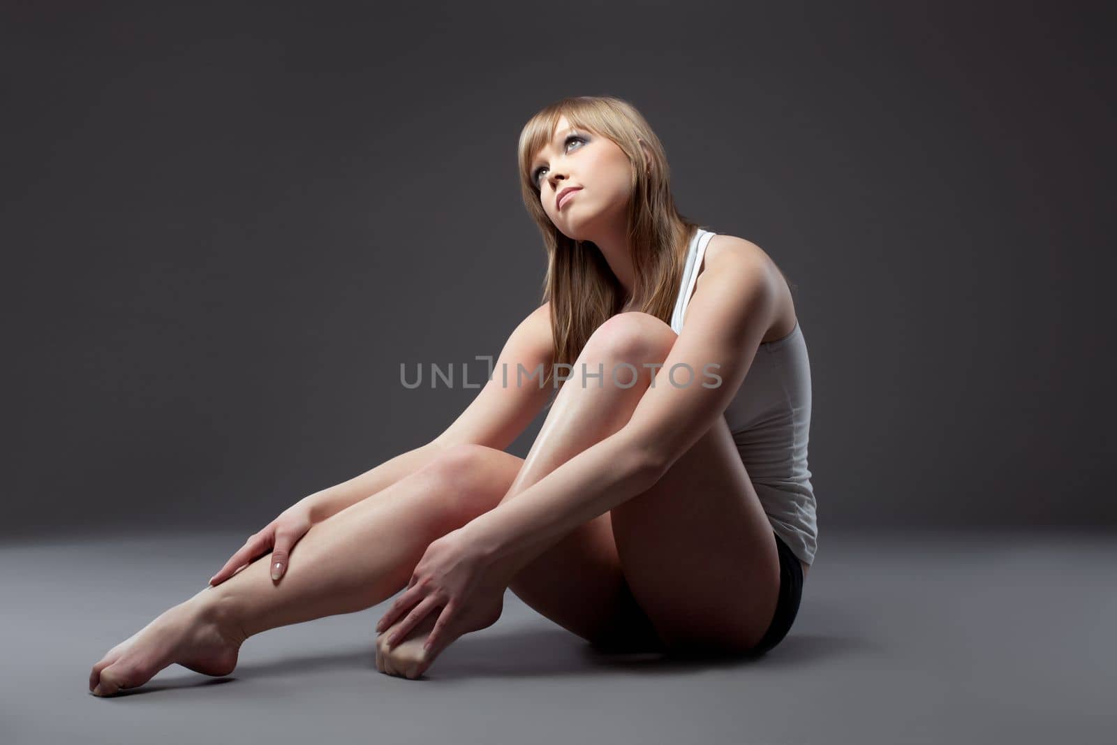 young gymnast girl portrait in dark - tank top and shirt - look at light