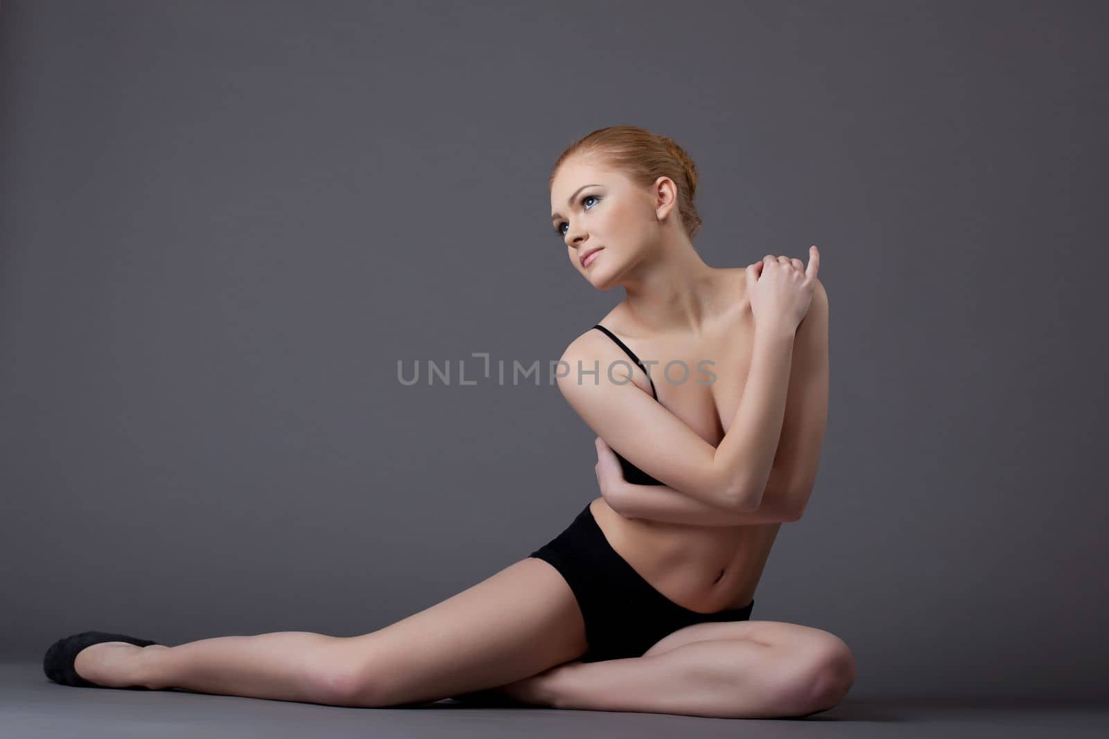 young gymnast girl portrait in dark - top and shirt - look at light