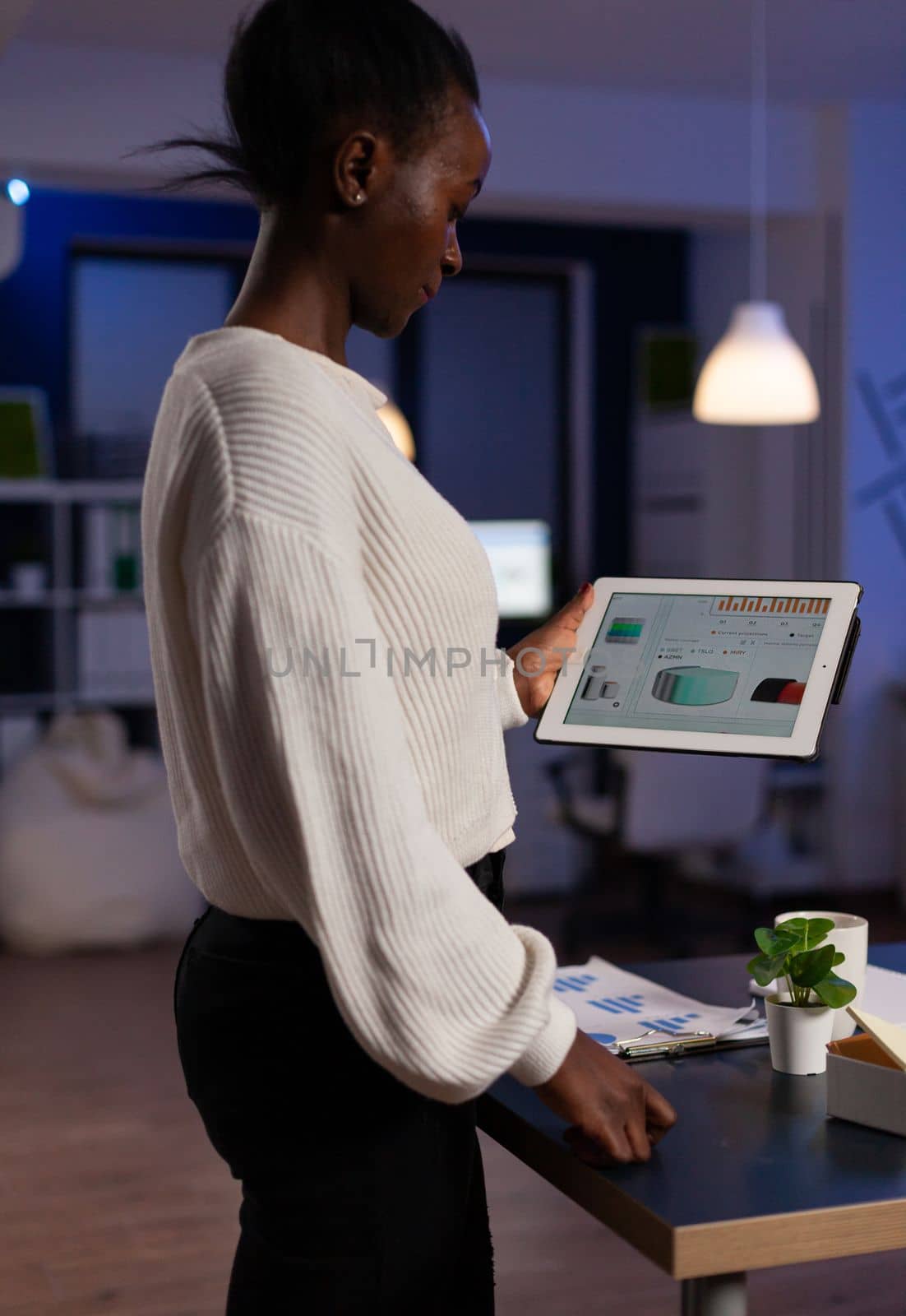 Concentrated african american executive manager holding tablet computer by DCStudio