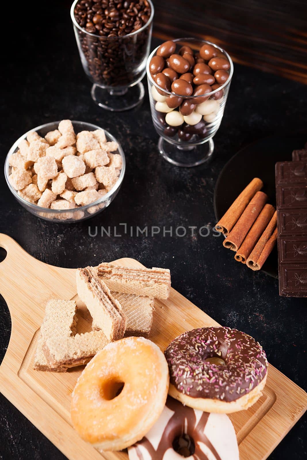 Donuts, peanuts in chocolate and coffee beans by DCStudio