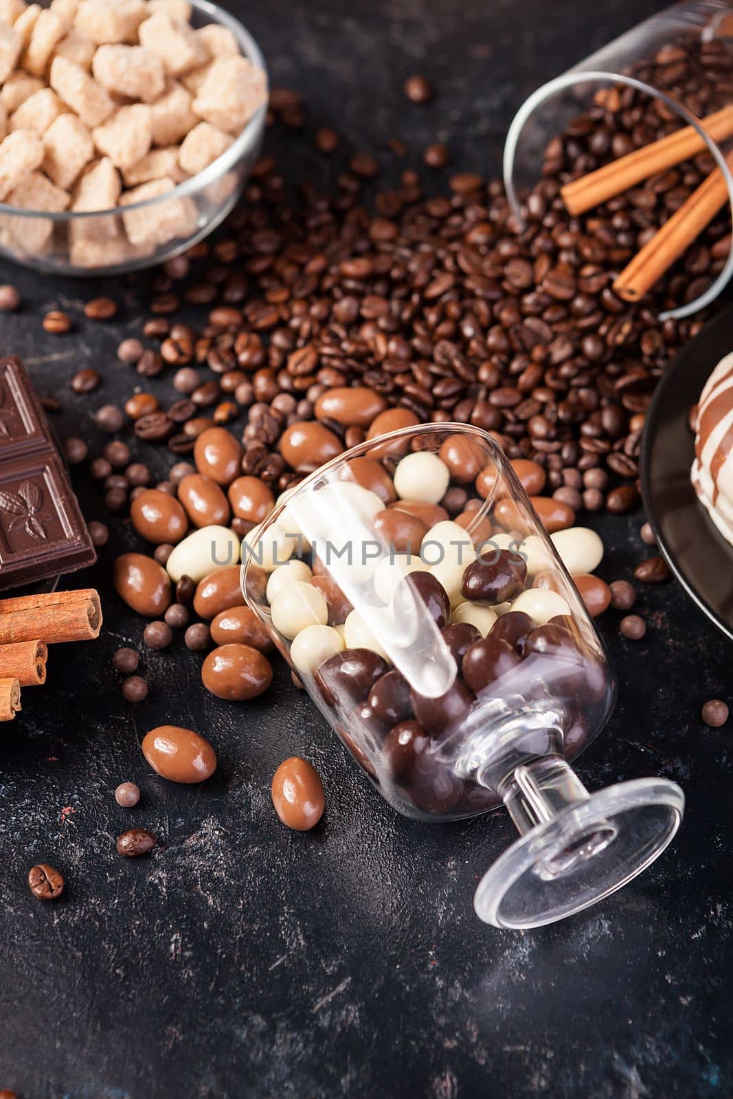 Composition from different type of candies on dark wooden background