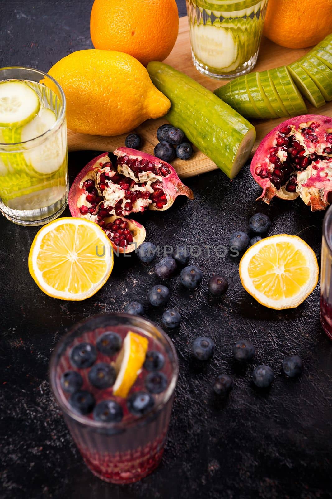 Homemade vitamin water from different fruits and vegetables on wooden board