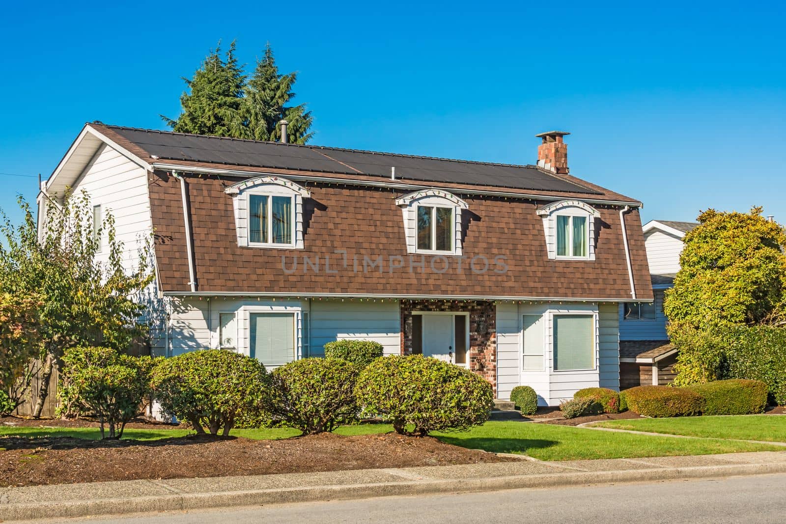 Big residential house on the street on sunny autumn day close to Cariboo Park, Burnaby, BC, Canada