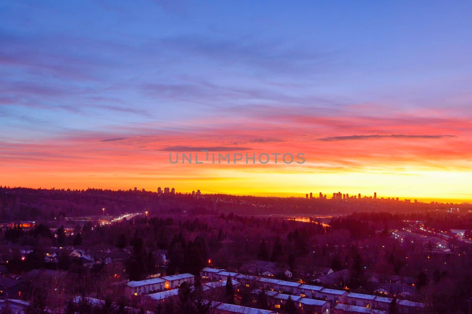 Suburban residential area on sunset sky background.