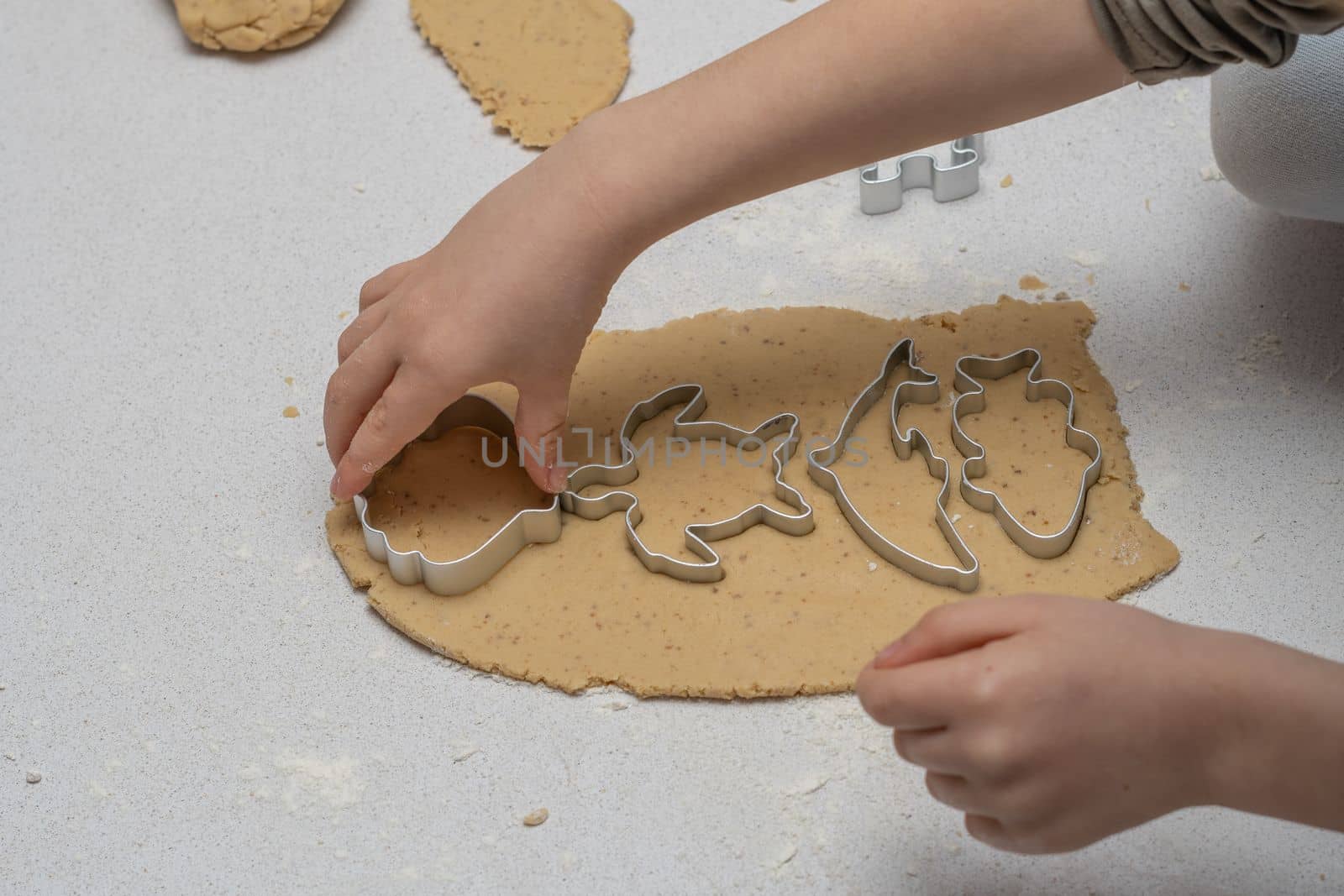 glass jar with brown sugar and a spoon in the background the hands of a woman preparing a cake