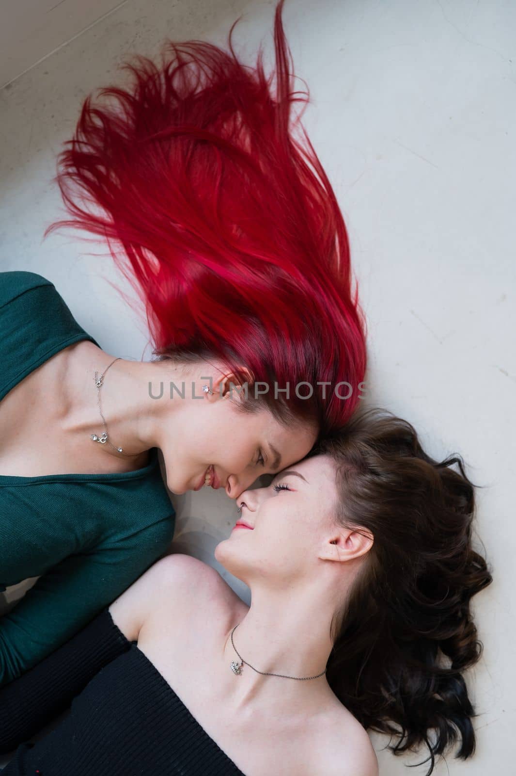 Top view of two women lying side by side. Lesbian intimacy