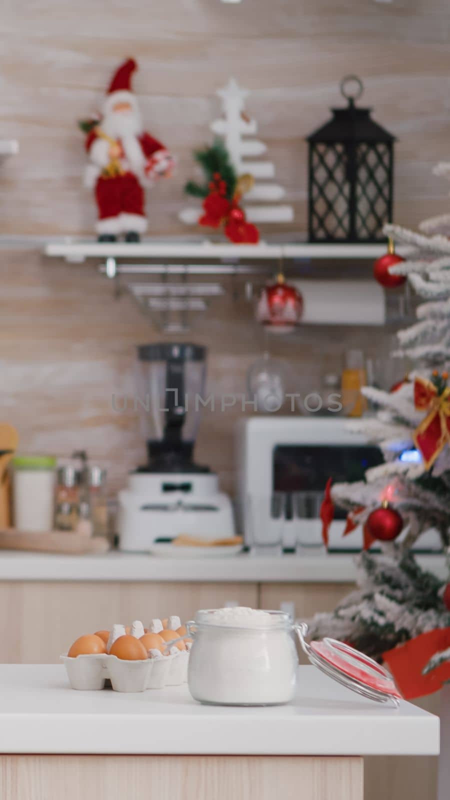 Empty christmas decorated culinary kitchen with nobody in it ready for traditional festive holiday by DCStudio