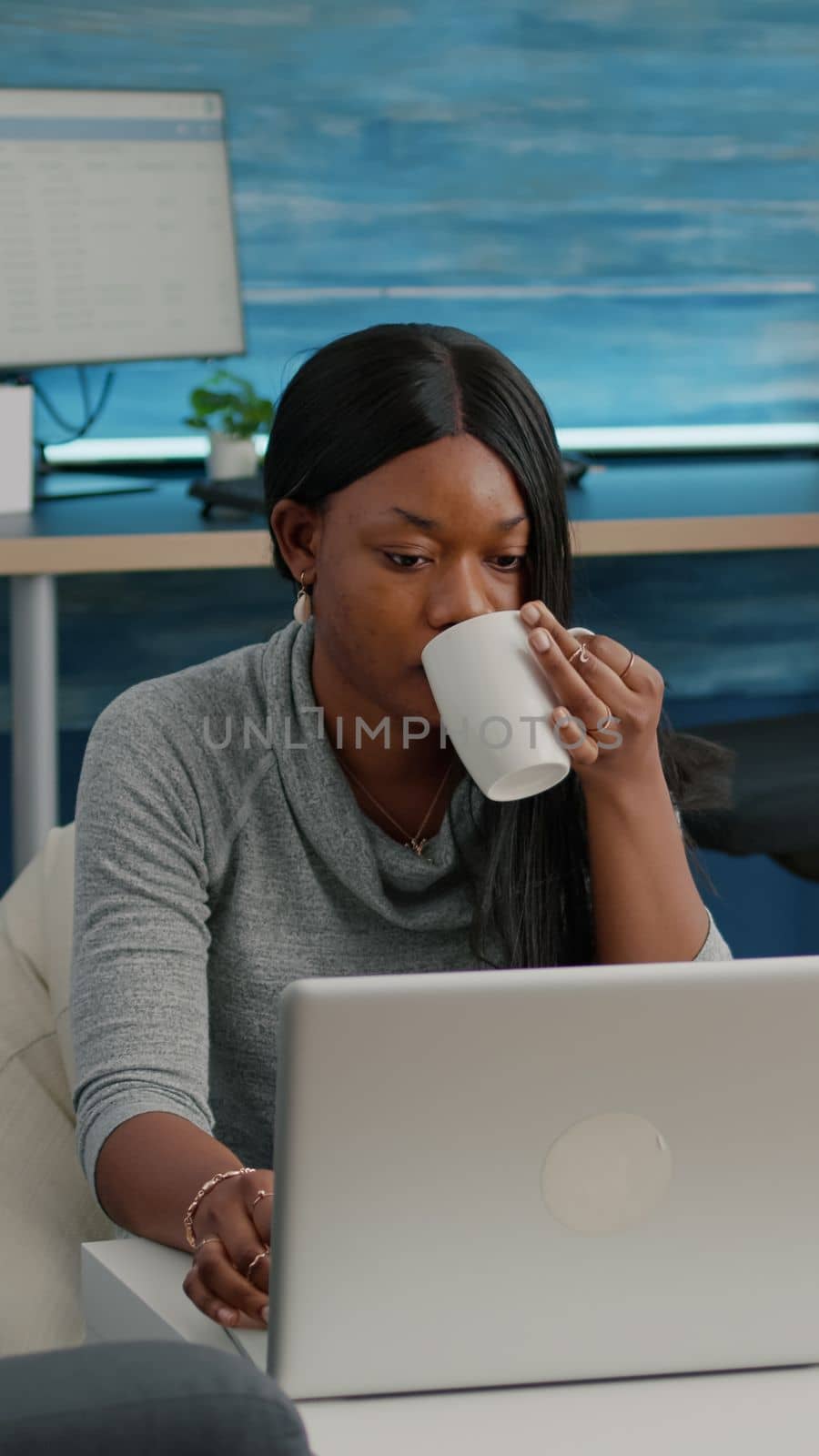 Black student drinking coffee typing social media article browsing lecture communication webinar by DCStudio
