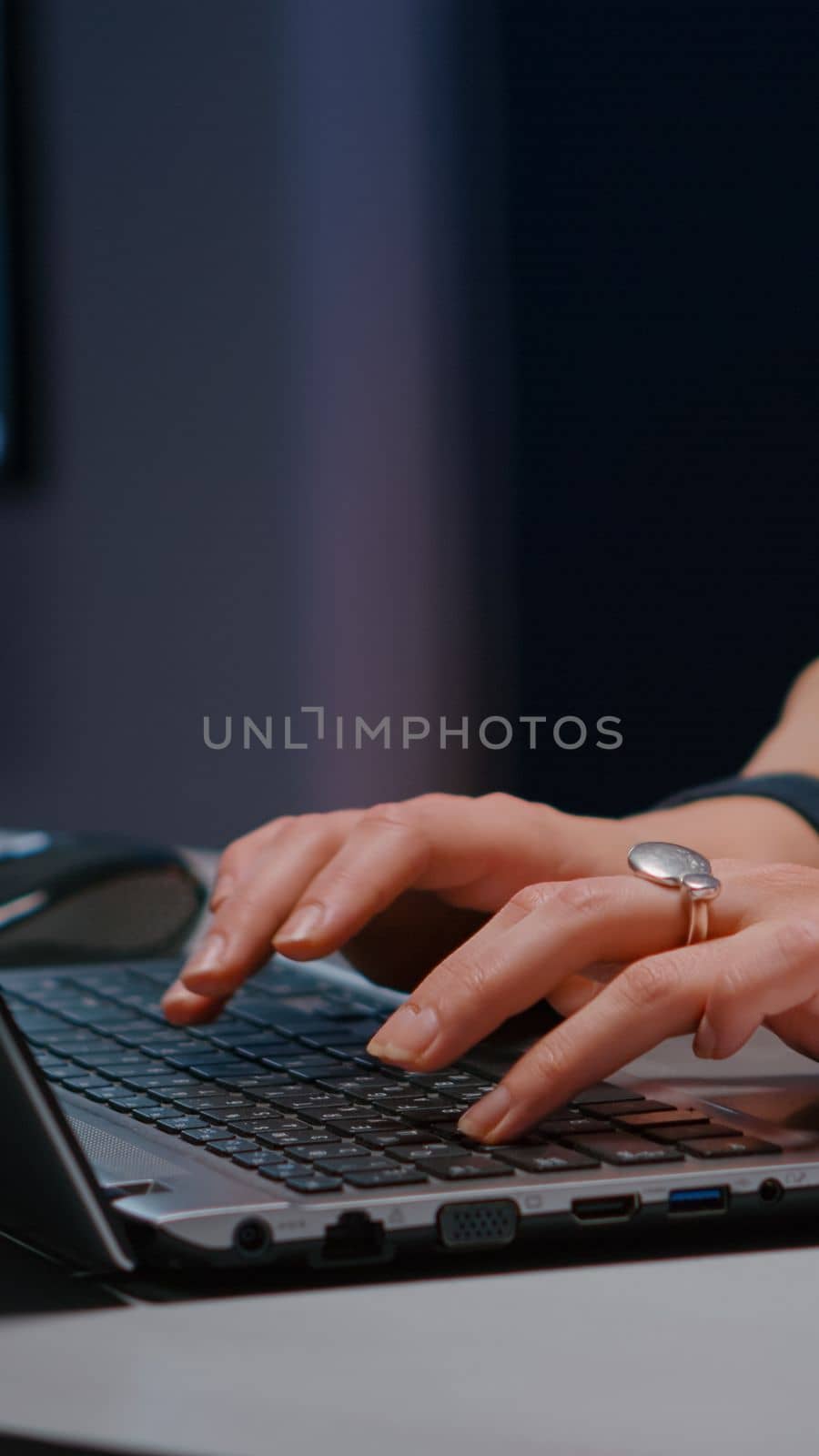 Close-up of businesswoman hands on keyboard sitting at desk in startup company office by DCStudio