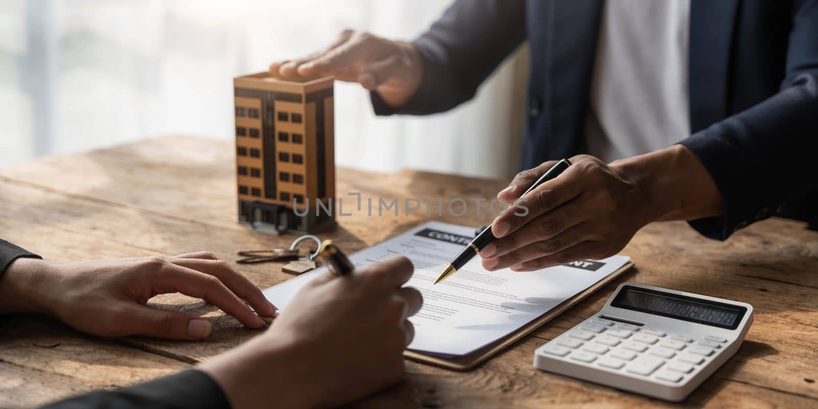 Real estate agent talked about the terms of the home purchase agreement and asked the customer to sign the documents to make the contract legally, Home sales and home insurance concept. by wichayada