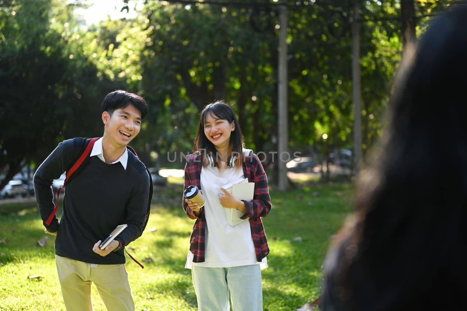 College friends walking in campus, having break after classes and talking to etch other. Youth lifestyle and friendship concept. 