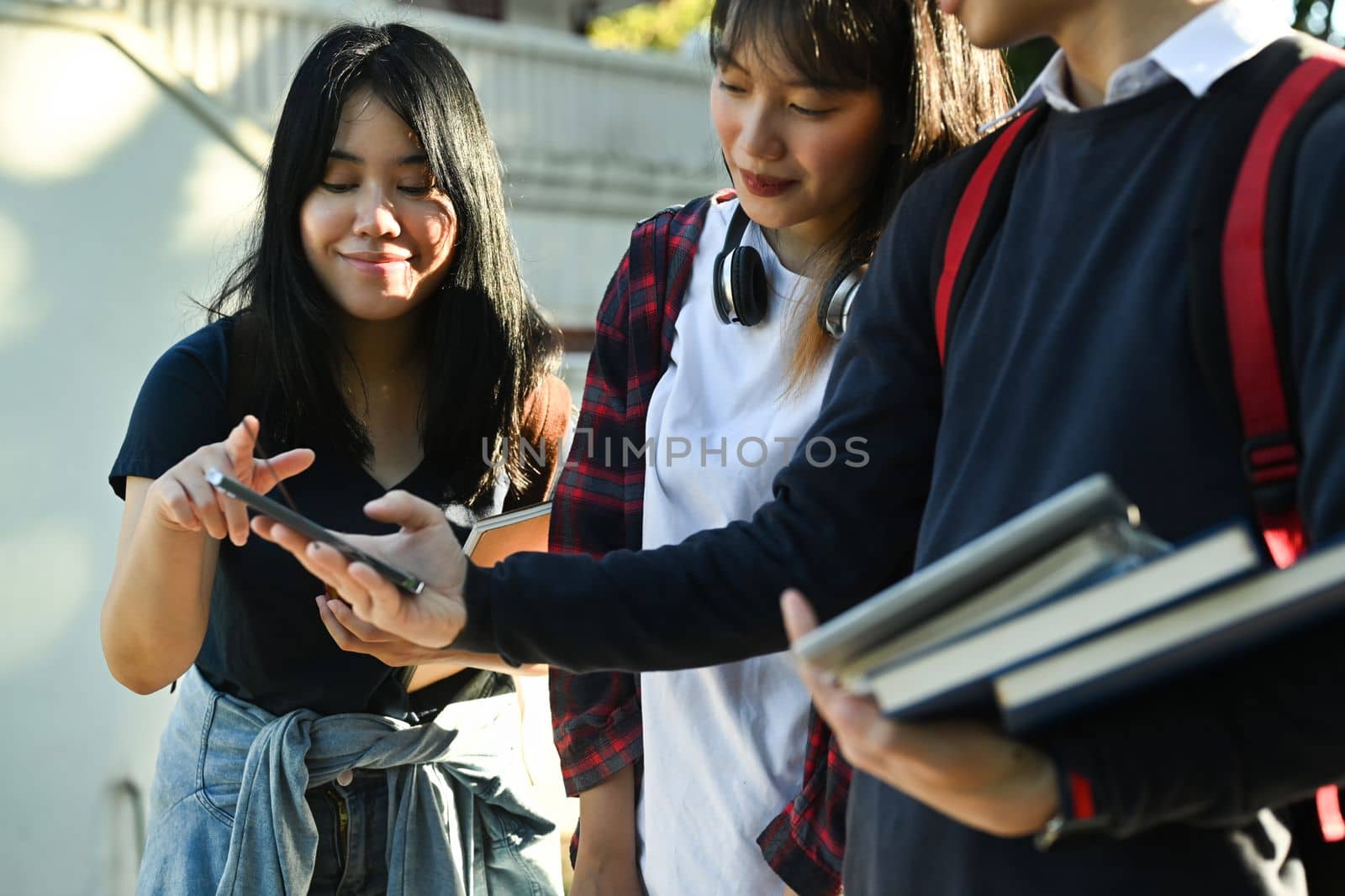 Group of college student having break after classes and talking to etch other. University, youth lifestyle and friendship concept.