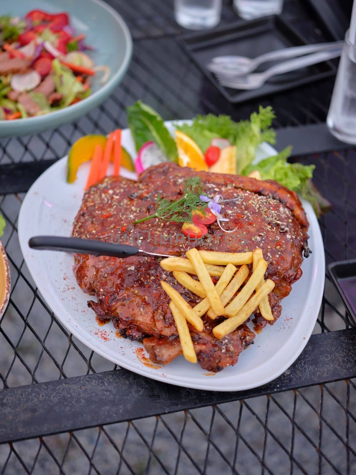 Grilled pork ribs with french fries on dish