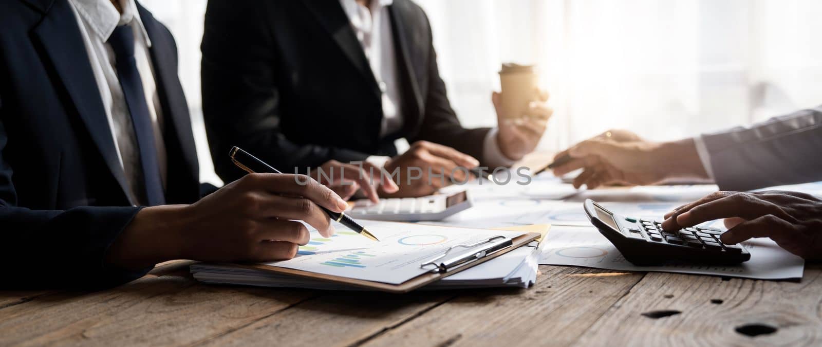 Business People Meeting using laptop computer,calculator,notebook,stock market chart paper for analysis Plans to improve quality next month. Conference Discussion Corporate Concept...