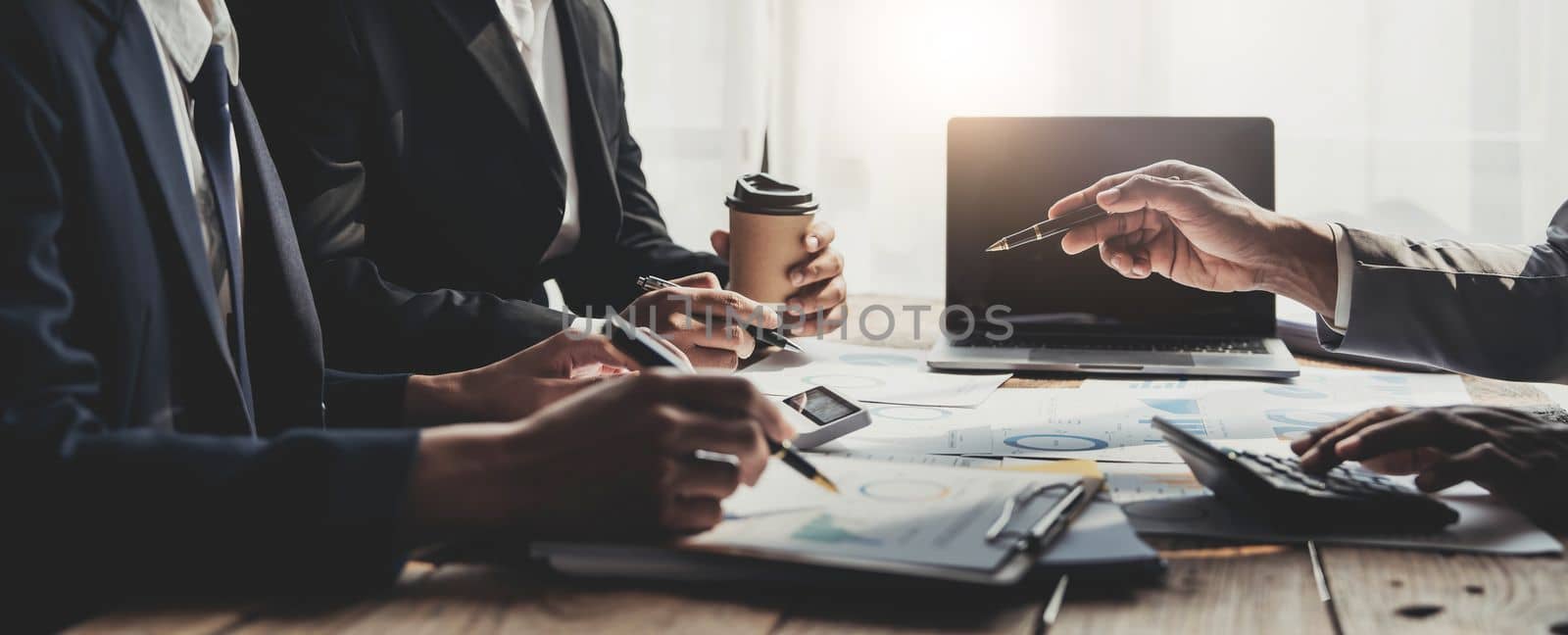 Business People Meeting using laptop computer,calculator,notebook,stock market chart paper for analysis Plans to improve quality next month. Conference Discussion Corporate Concept...