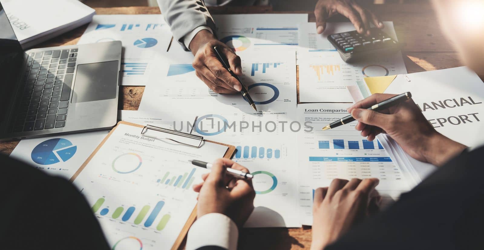 Business People Meeting using laptop computer,calculator,notebook,stock market chart paper for analysis Plans to improve quality next month. Conference Discussion Corporate Concept...