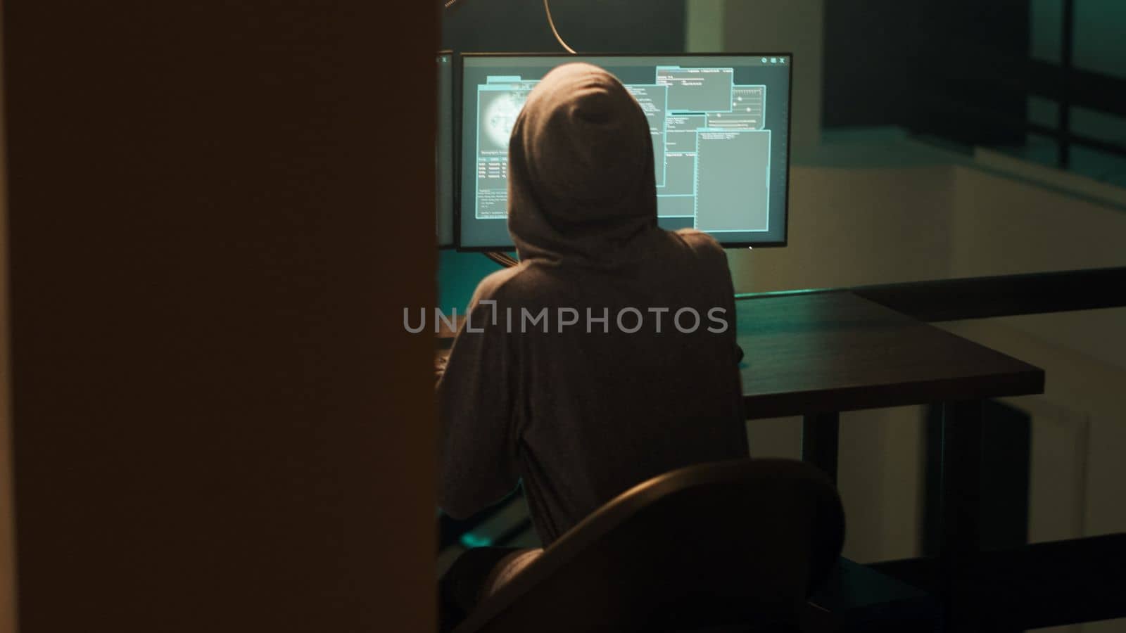 Female spy breaking into computer firewall to hack system, feeling happy about cybercrime success. Woman using malware or trojan virus, doing phishing espionage for hacktivism. Handheld shot.