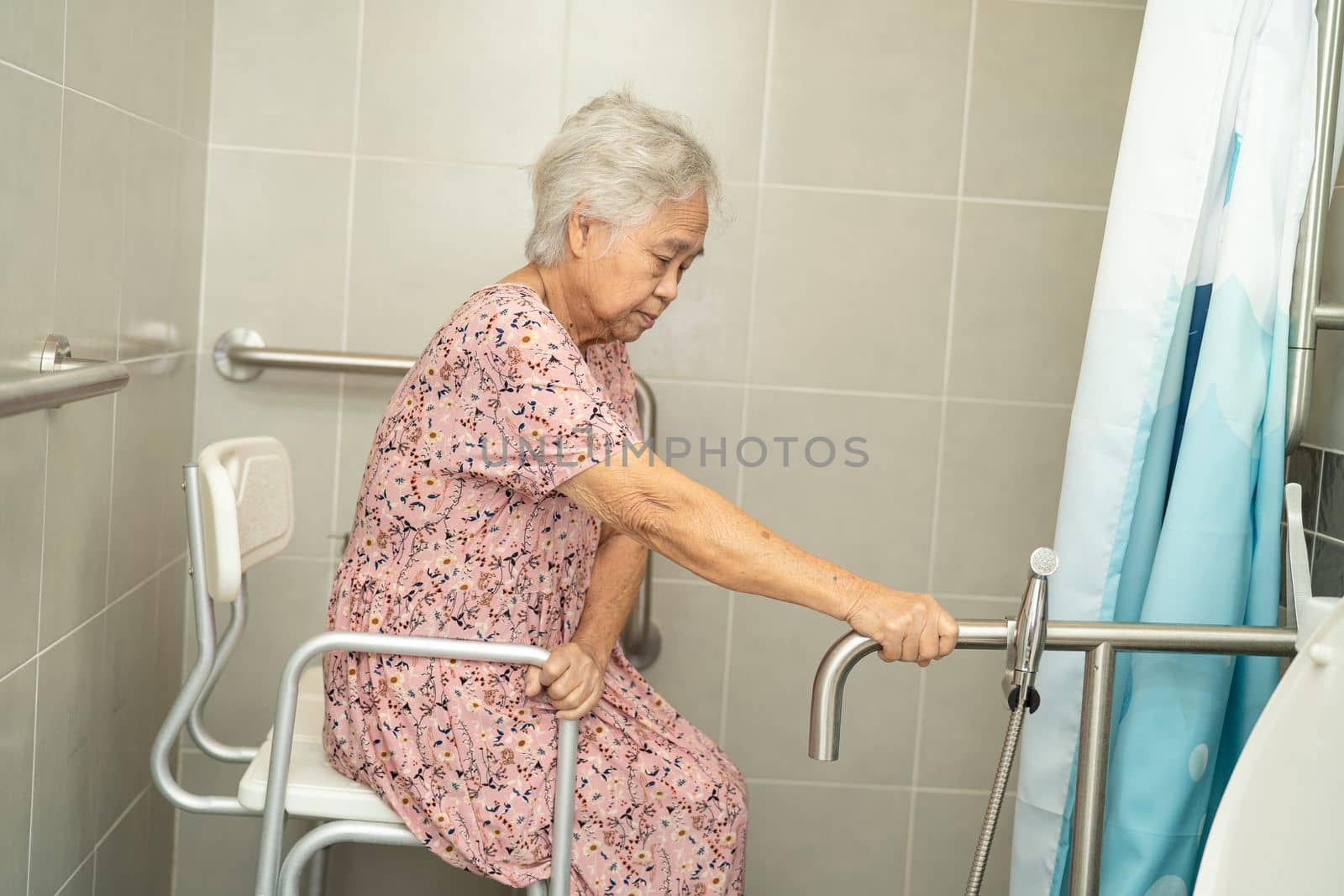 Asian elderly woman patient use toilet bathroom handle security in nursing hospital ward, healthy strong medical concept.