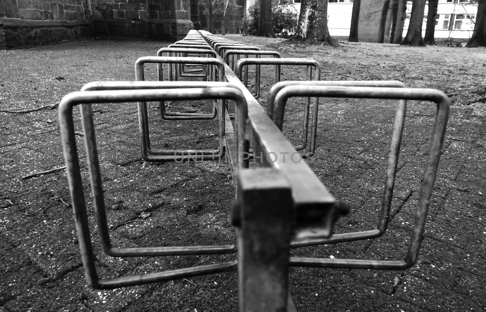 Row of bicycle stands at a church in black and white. Location: Emlichheim, Germany