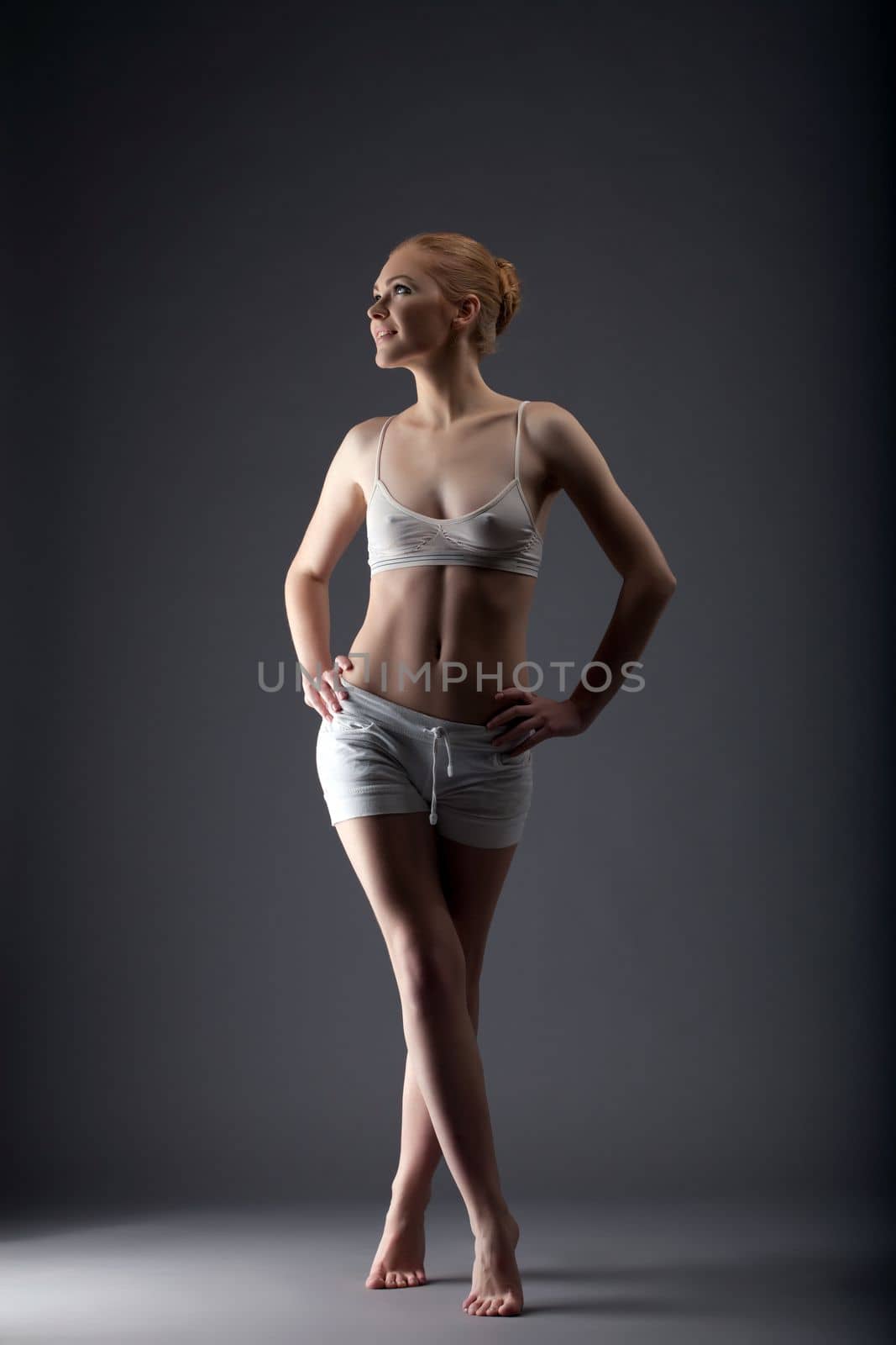 young sexy gymnast girl walk in training cloth look at light
