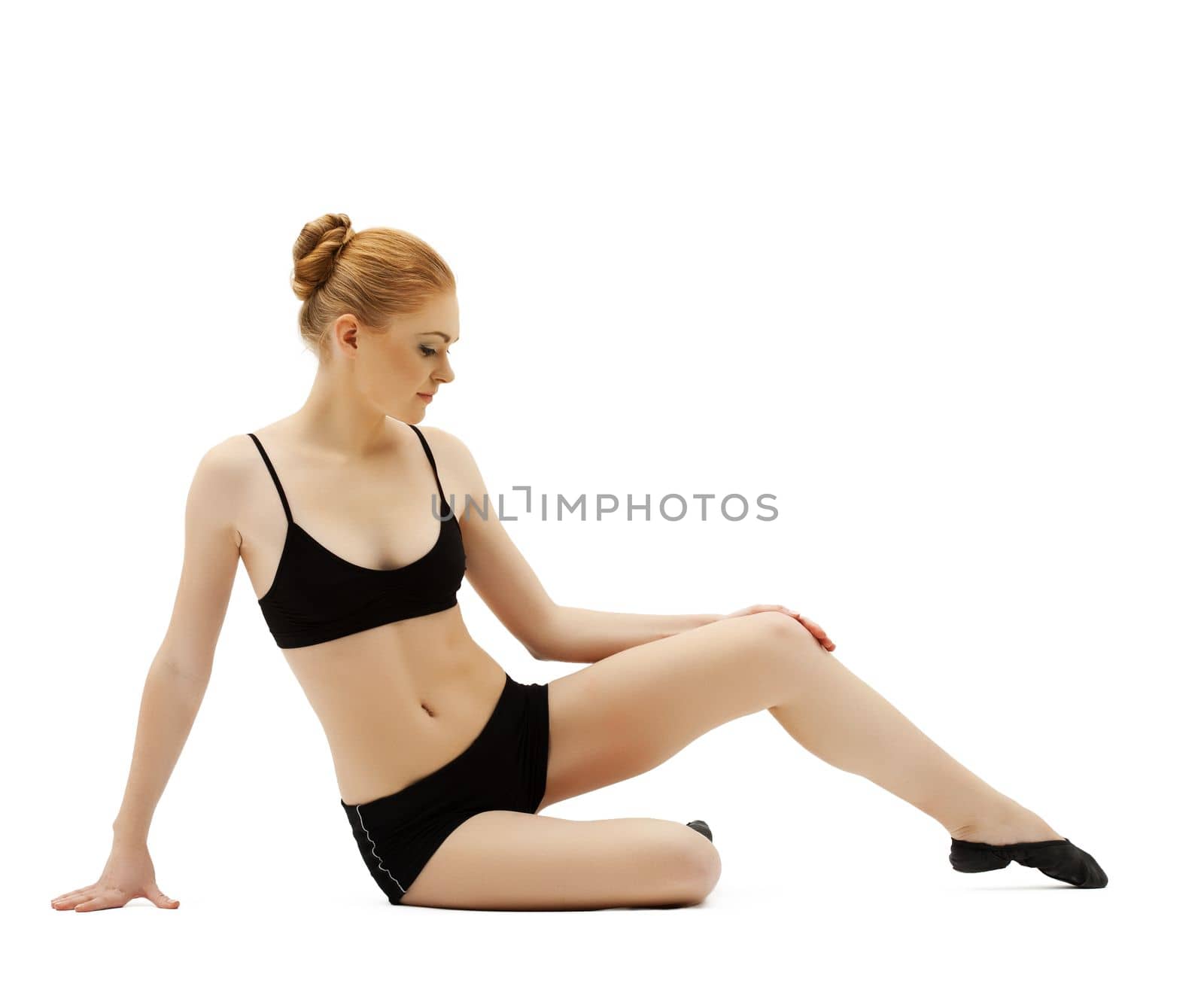young gymnast girl in black top posing on white isolated