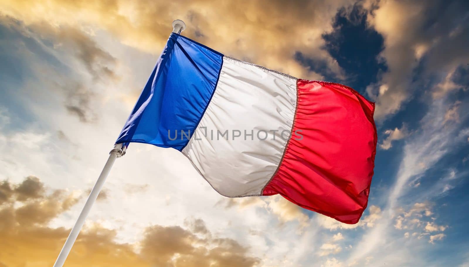 France flag in a sunset sky. French national flag.