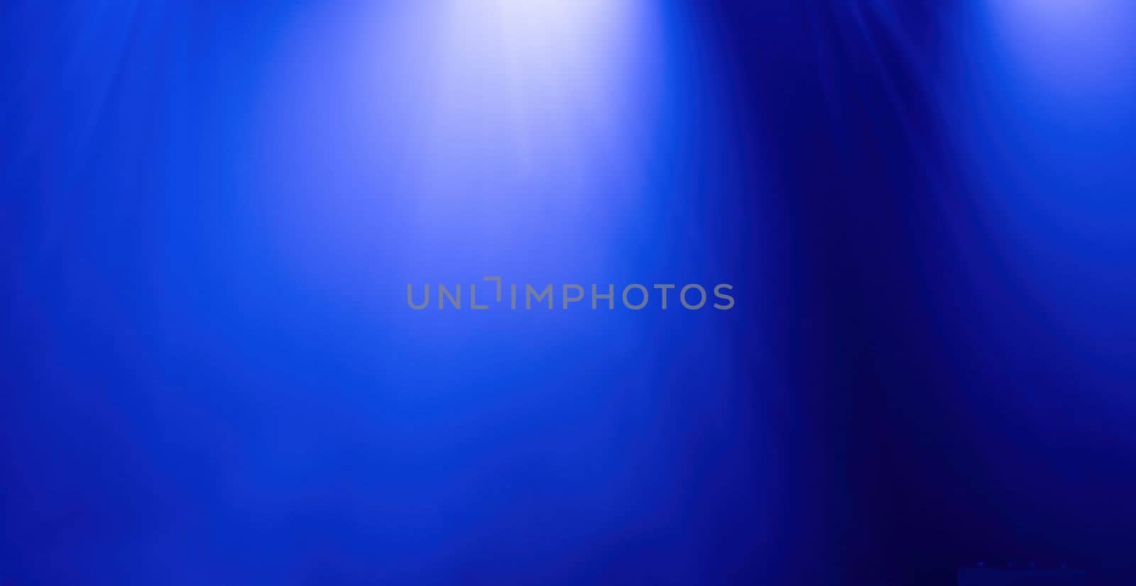 Background of blue light of stage from spotlights projectors, abstract background